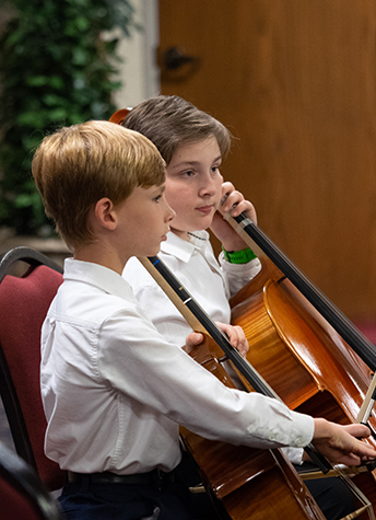 2 boys playing cello