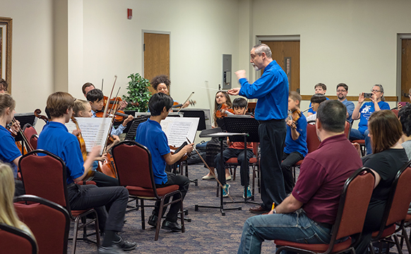 Students playing in blue shirts