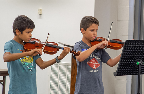 2 boys reading music